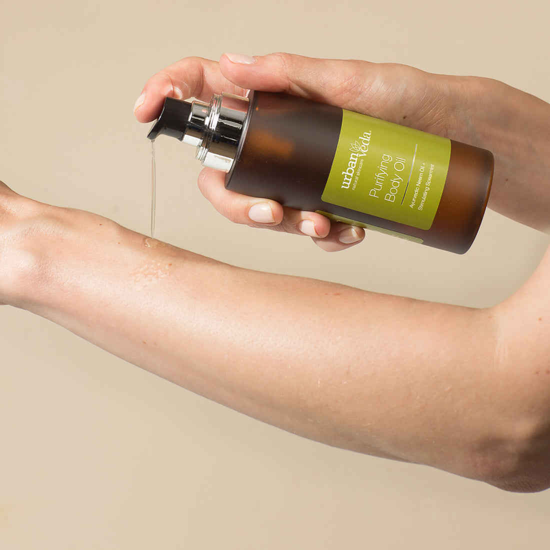 Applying purifying body oil for lymphatic massage as part of a daily Ayurvedic body care ritual - Urban Veda