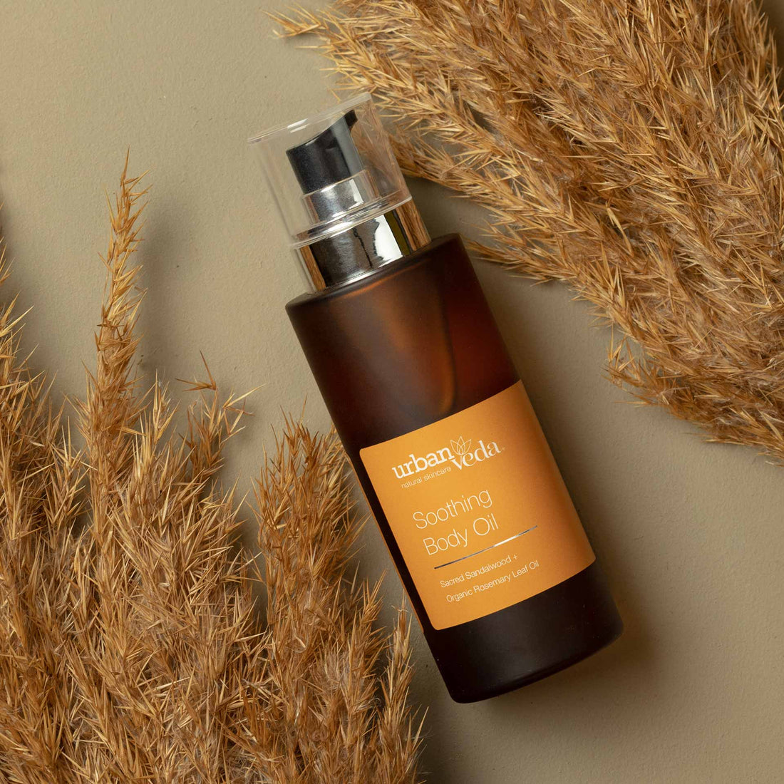 best body oil for dry skin, Urban Veda Amber bottle against a light background
