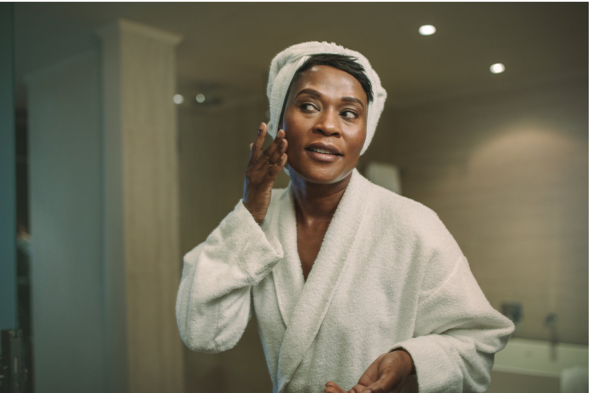 Mature woman applying Vitamin A skincare