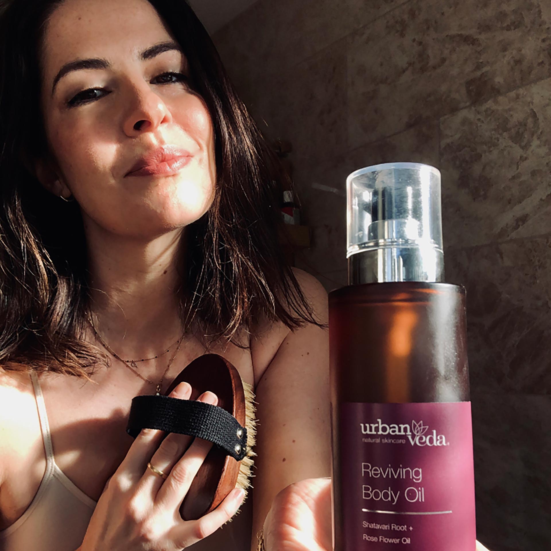 Applying firming body oil to mature skin for improved elasticity and smoothness - Urban Veda
