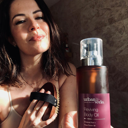 Applying firming body oil to mature skin for improved elasticity and smoothness - Urban Veda